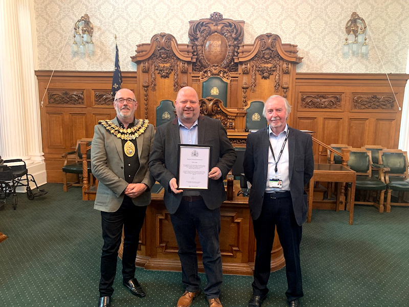 Phil Cooke receives his award from the Mayor of Stockport